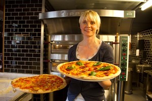 Uta Wellmann mit den ersten Pizzen im L'Osteria Rostock